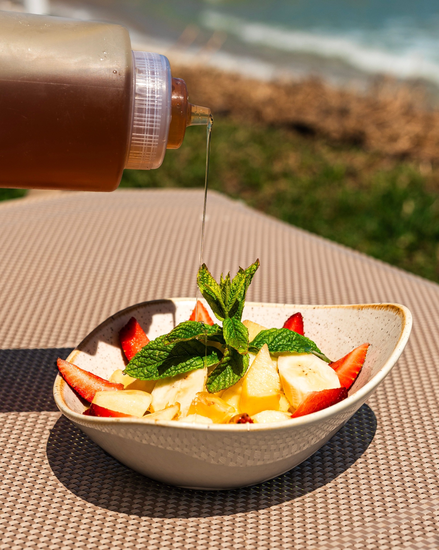 Honey drizzled over a fresh fruit bowl
