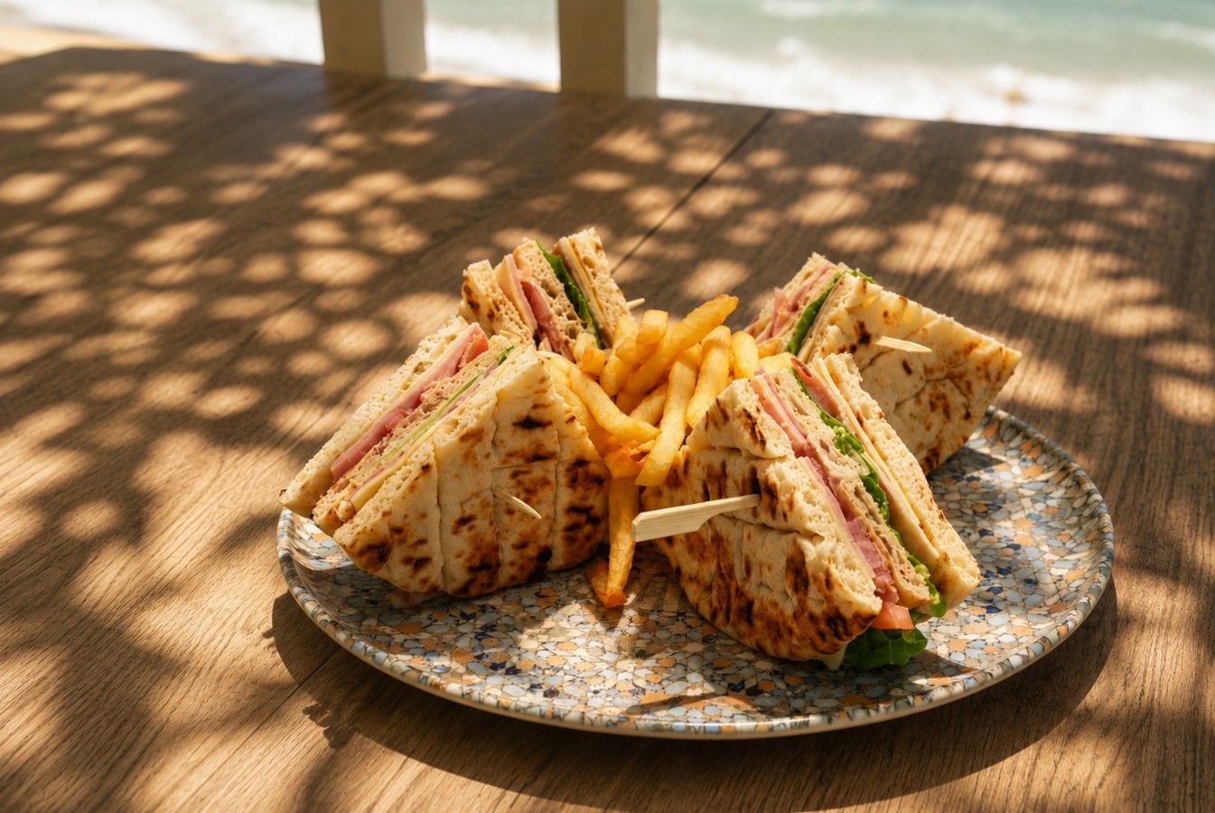 Club sandwich with fries by the sea